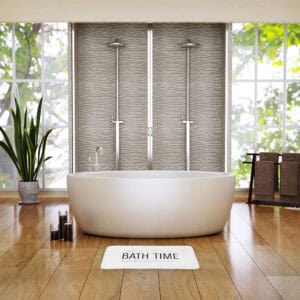 White bath mat in spa-like bathroom with freestanding tub and textured tile shower wall
