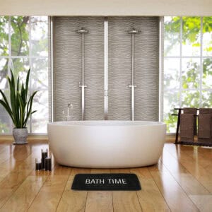 Black bath mat in spa-like bathroom with freestanding tub and textured tile shower wall