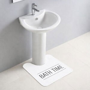 "White 'Bath Time' contour rug beneath pedestal sink on white tile"