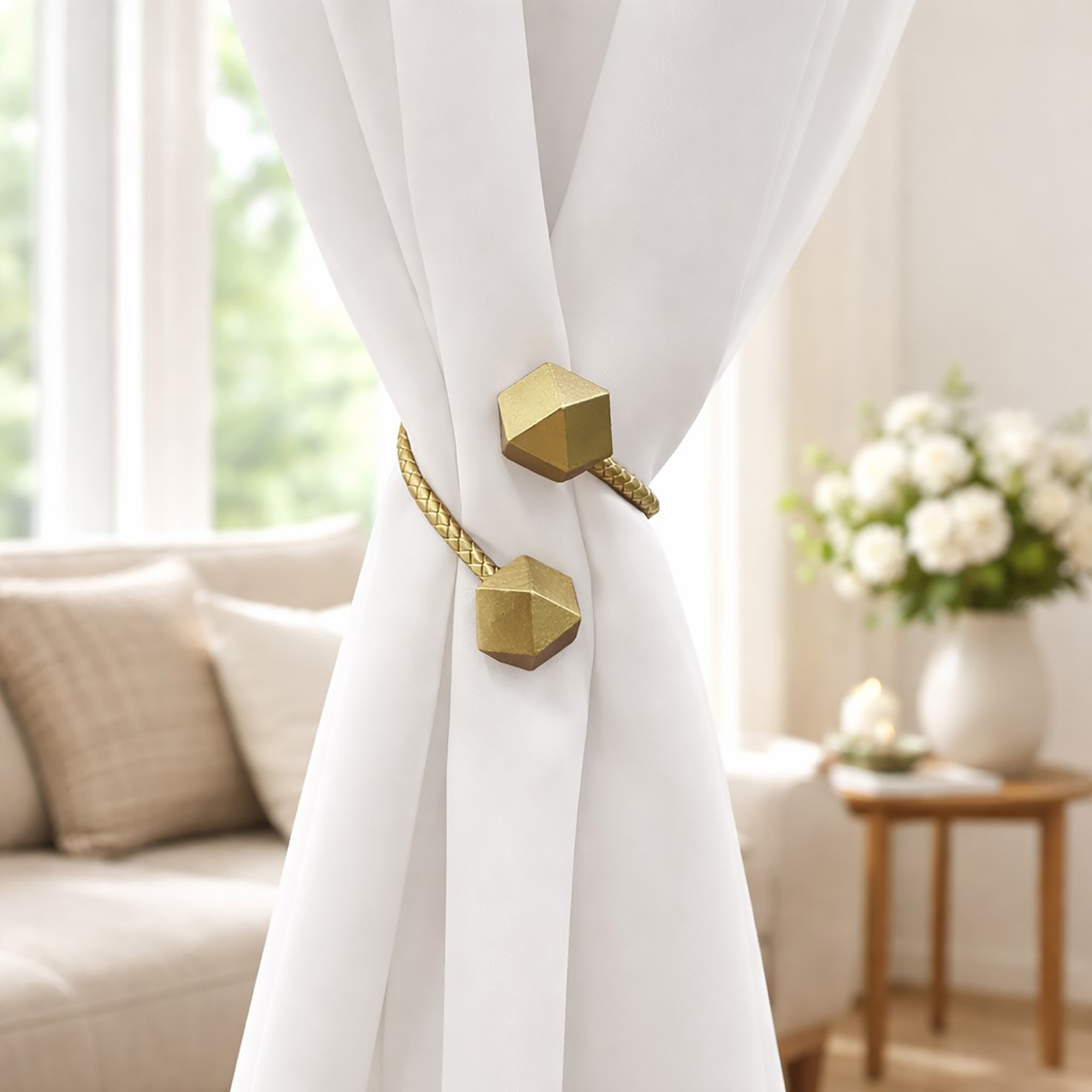 Gold geometric tieback fastened around white curtain, bright living room setting