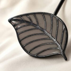 Macro view of the taupe stained-glass resin leaf with raised veins