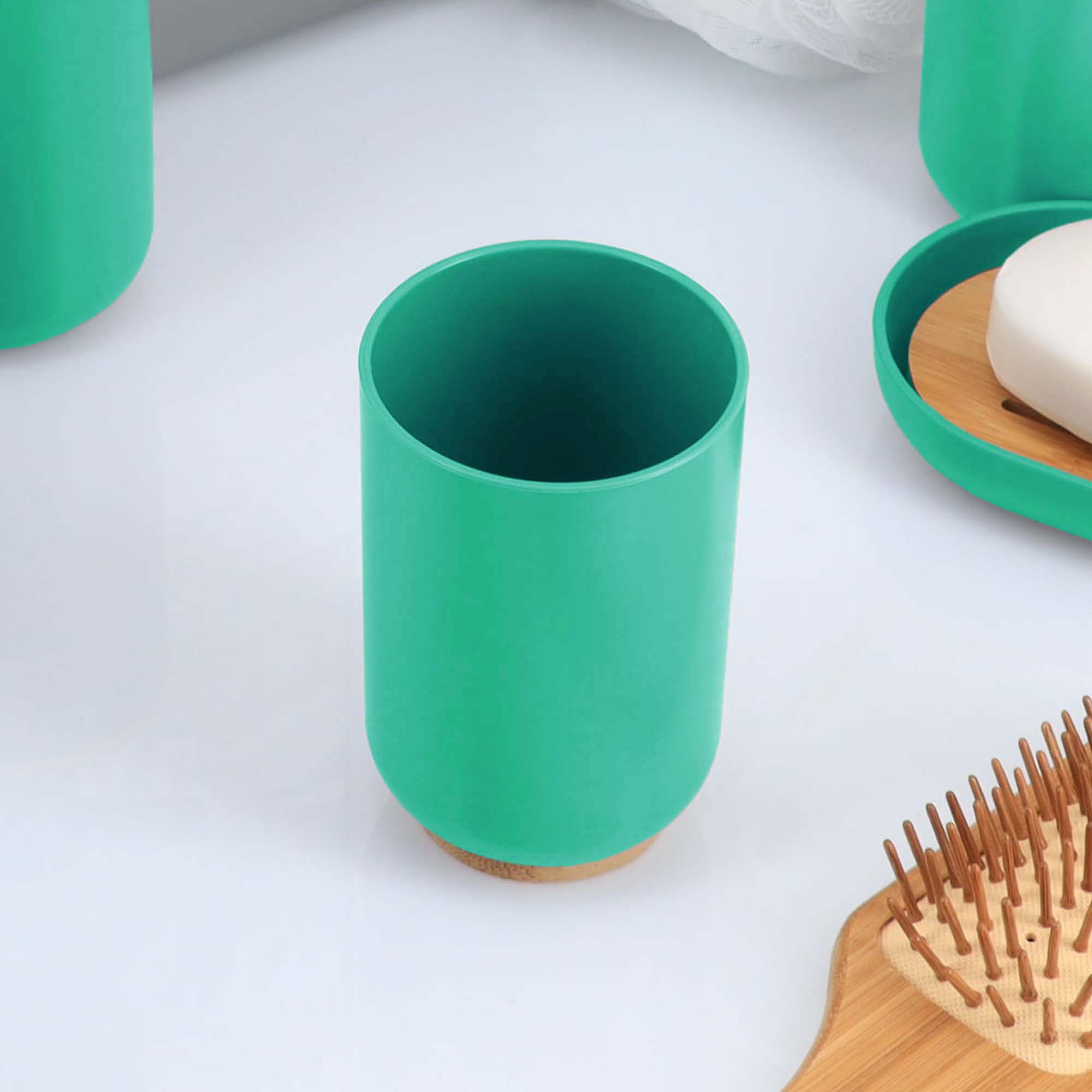 Green bamboo base tumbler on white surface