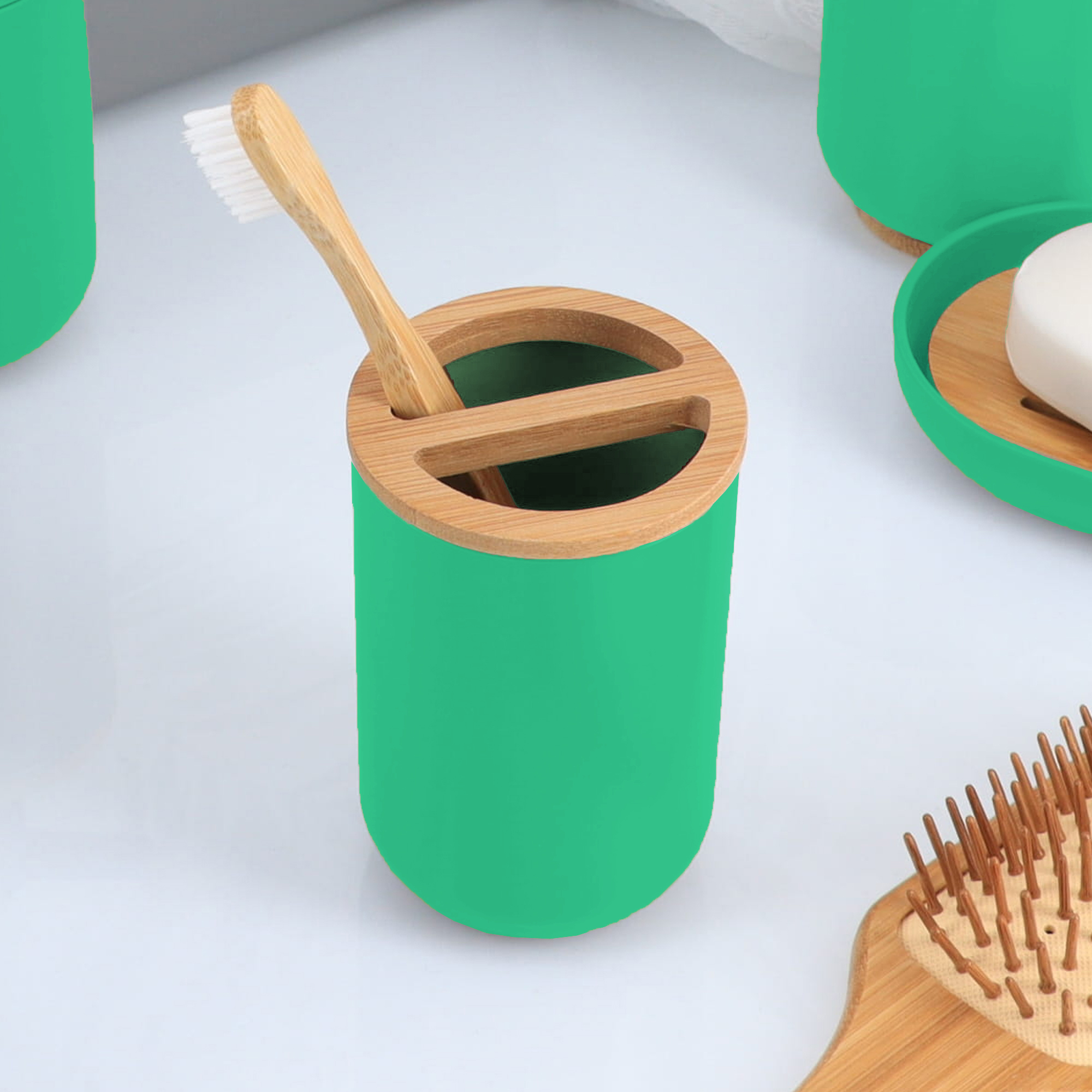 Bamboo toothbrush inside green bathroom toothbrush holder