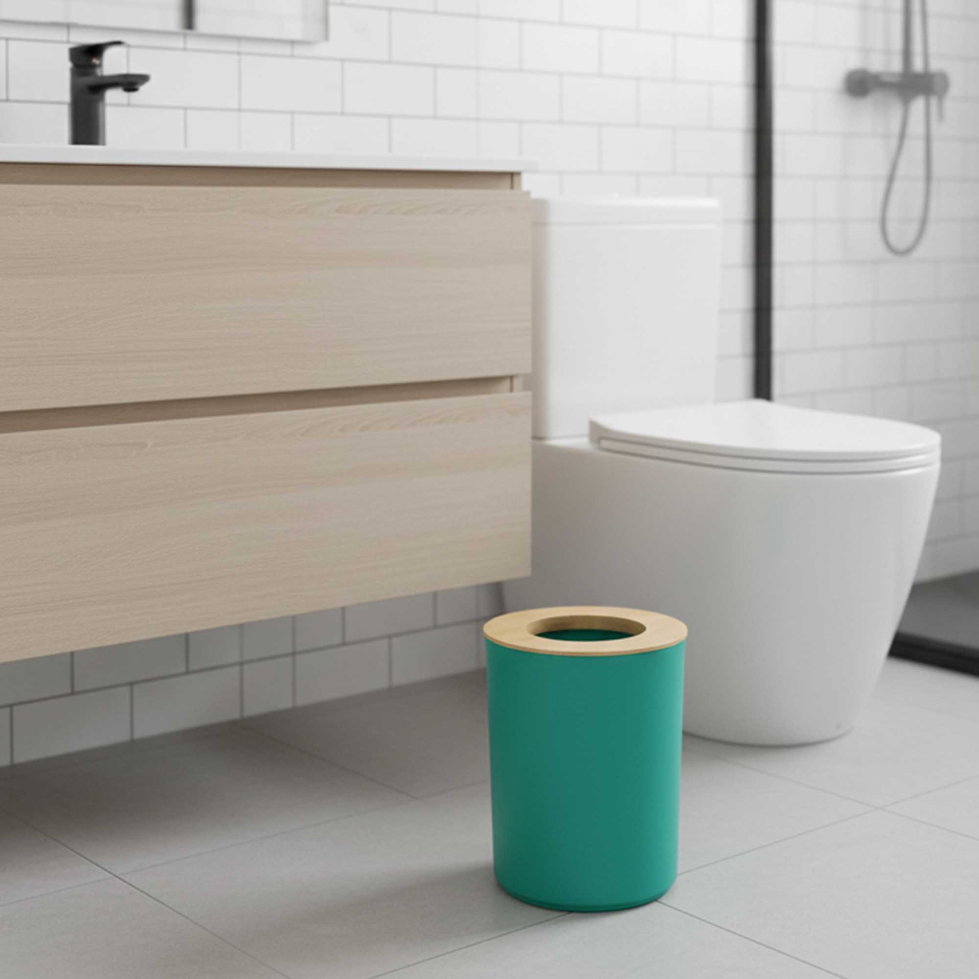 Modern bathroom scene with green trash can and bamboo top
