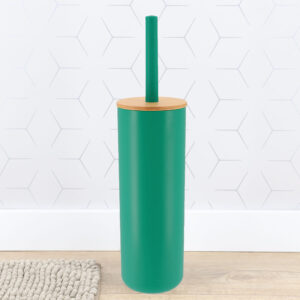Teal green toilet brush holder with bamboo lid against white hexagonal tile wall