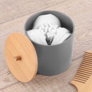 Gray cotton swab holder with bamboo lid and divided interior