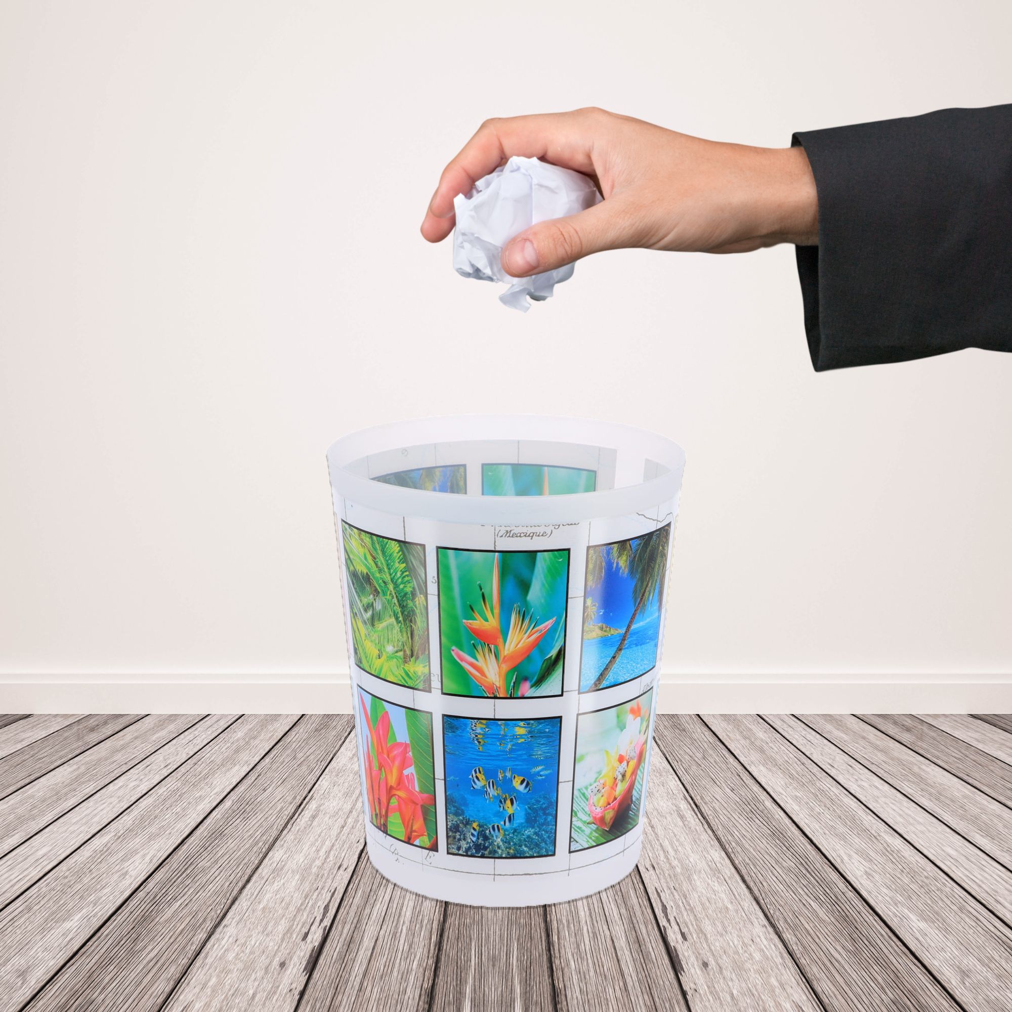 Hand dropping paper into island design waste basket