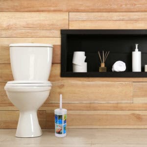 "Compact toilet brush with island graphics in modern wood-paneled bathroom"