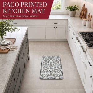 The kitchen mat placed on a tiled floor in a bright modern kitchen with white cabinets and a gas range, adding pattern and comfort underfoot.