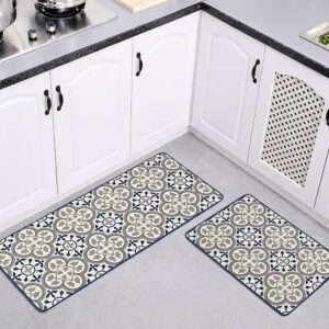 Both kitchen mats laid on a gray floor in a white kitchen with arched cabinet doors, the runner and smaller mat showing their blue and gray pattern.