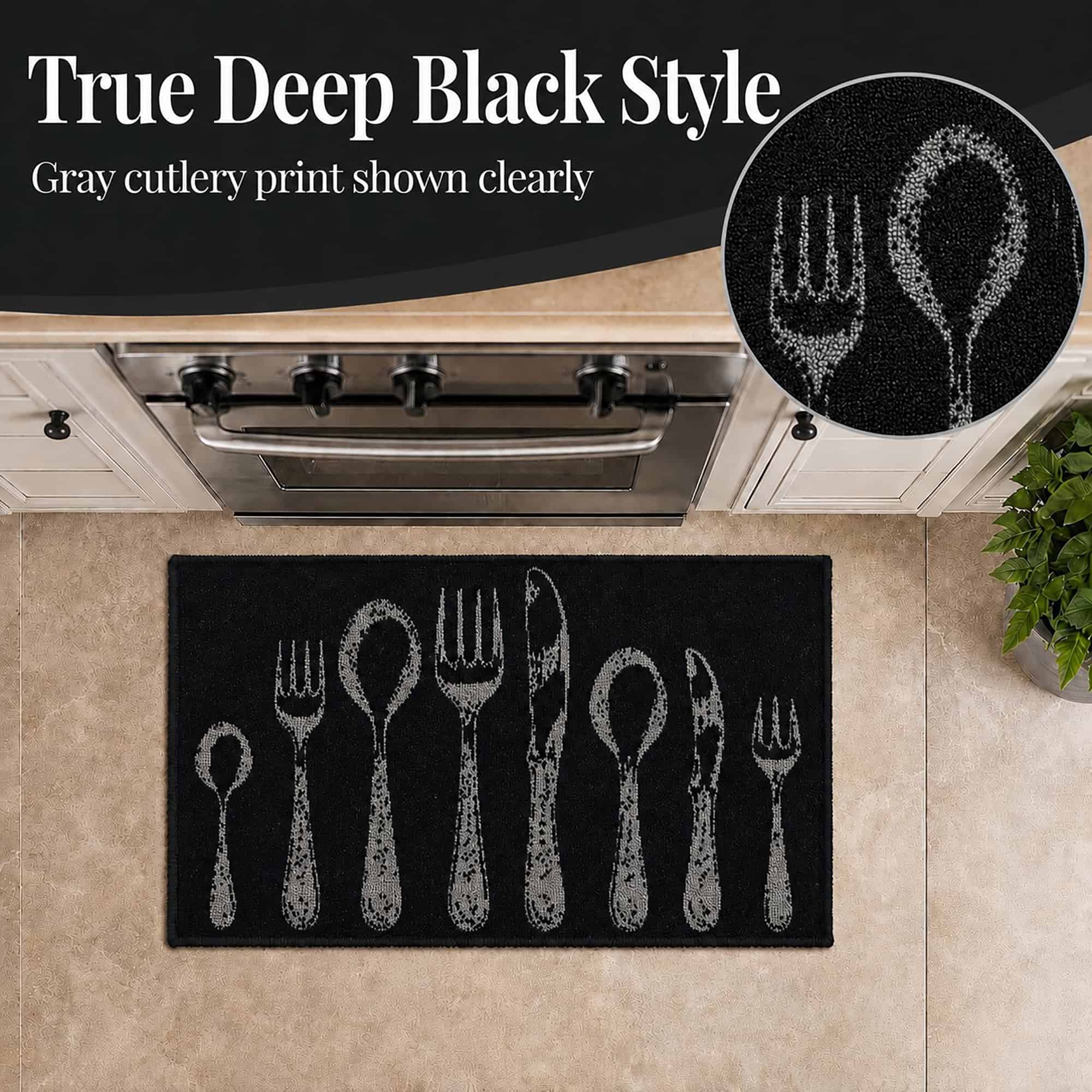 Close view of the deep black accent rug with gray cutlery print, a circular inset magnifying the textured fork and spoon design near a stove.
