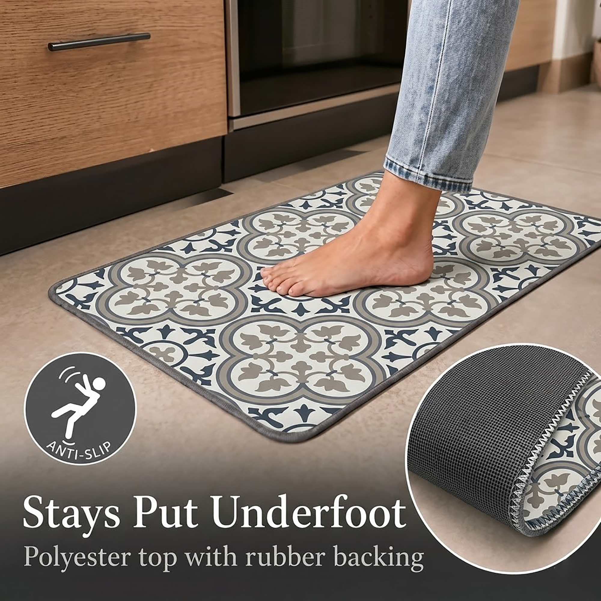 A bare foot resting on the standard kitchen mat near wood cabinets, with one corner flipped up to reveal the textured rubber anti-slip backing.