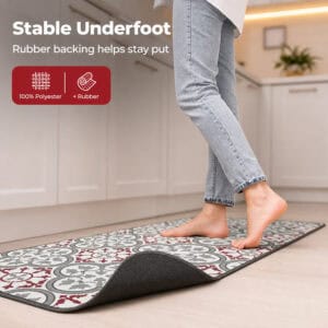 A bare foot steps onto the kitchen runner with one corner curled up to reveal the gray rubber backing, labeled one hundred percent polyester with rubber.