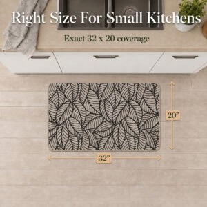Overhead view of a beige leaf-print kitchen mat with arrows marking thirty-two inches wide by twenty inches deep for small kitchens.