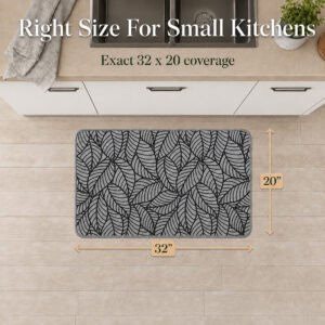 Overhead view of a grey leaf-print kitchen mat with arrows marking thirty-two inches wide by twenty inches deep for small kitchens.