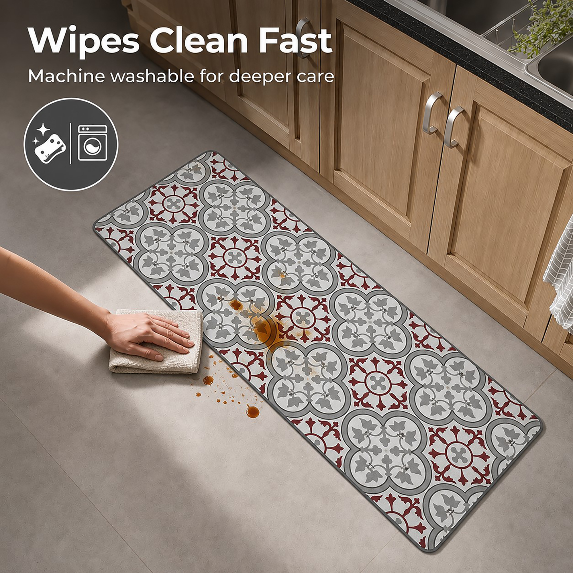 A hand wipes a brown spill from the long kitchen runner with a cloth, showing how the machine washable mat cleans up quickly.