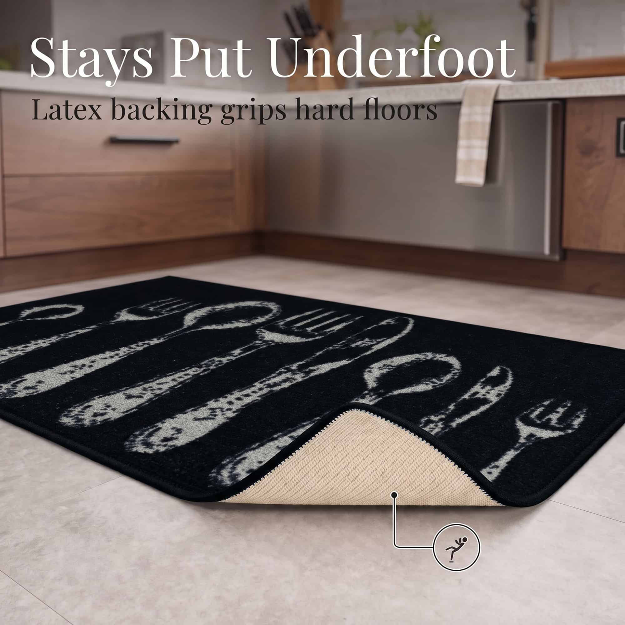 Corner of the black non slip kitchen mat folded back to reveal the tan latex backing that grips hard floors and helps prevent slipping.