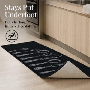 Corner of the black non slip set folded back to show the tan latex backing that helps reduce shifting on hard floors.