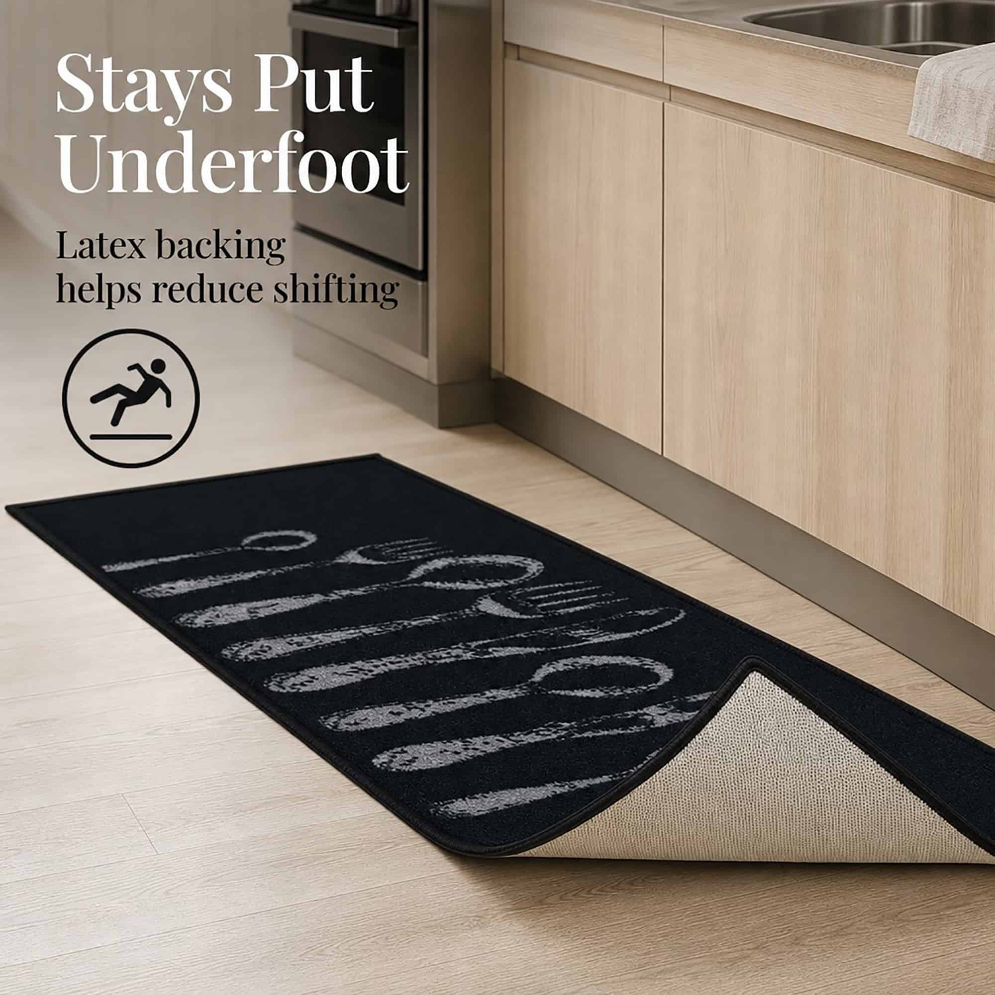 Corner of the black non slip set folded back to show the tan latex backing that helps reduce shifting on hard floors.