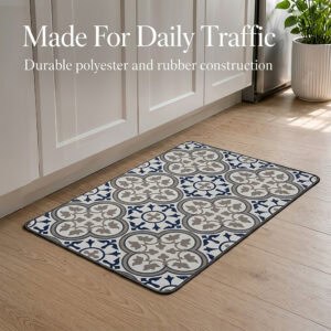 The kitchen mat lying on a light wood floor beside white cabinets and a potted plant, built from durable polyester and rubber for daily traffic.