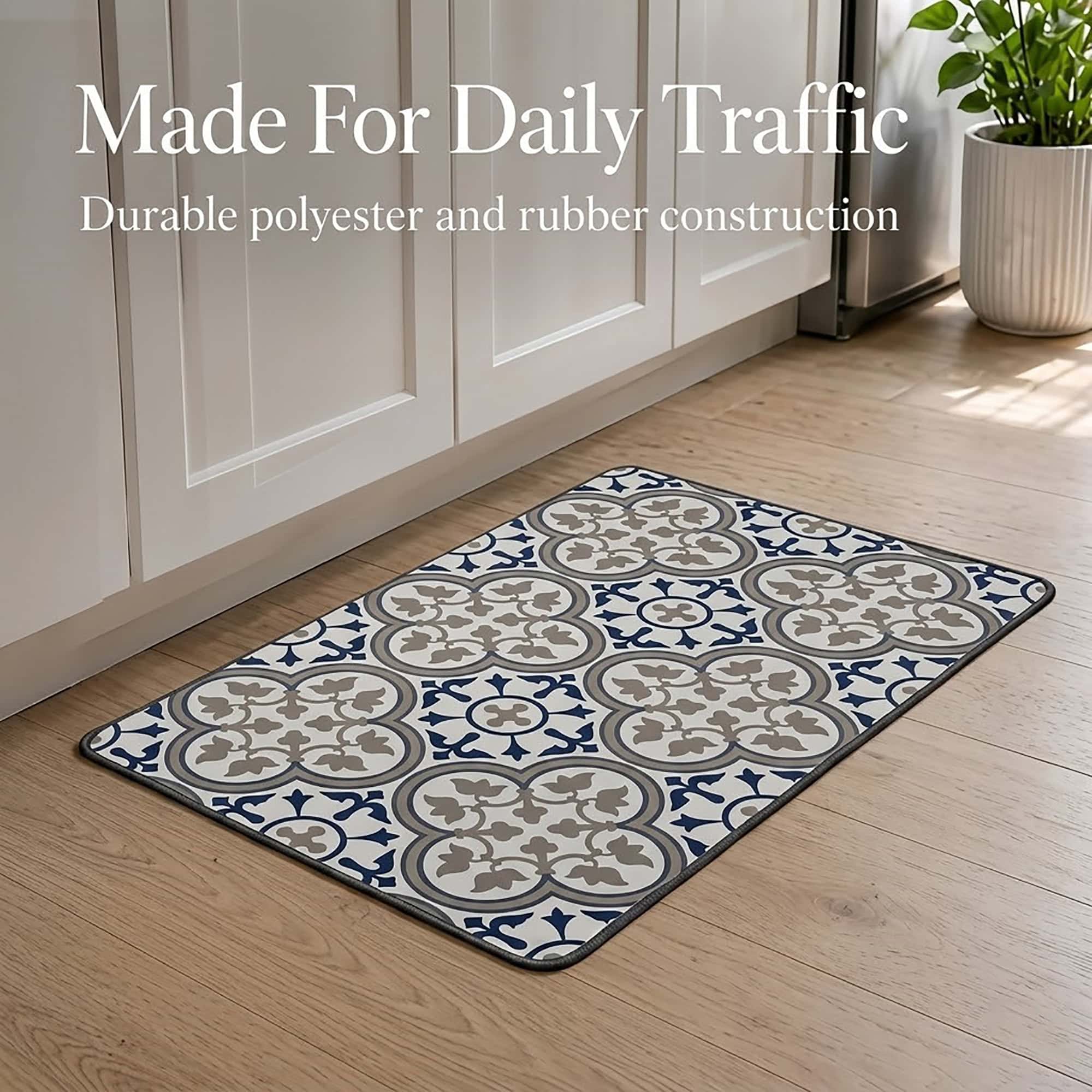 The standard kitchen mat lying on a wood floor beside white cabinets and a leafy plant, built to handle everyday foot traffic.