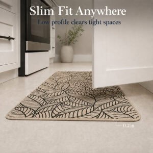 Beige leaf-print kitchen runner lying flat in a bright kitchen, its low two-tenths of an inch profile clearing tight spaces.