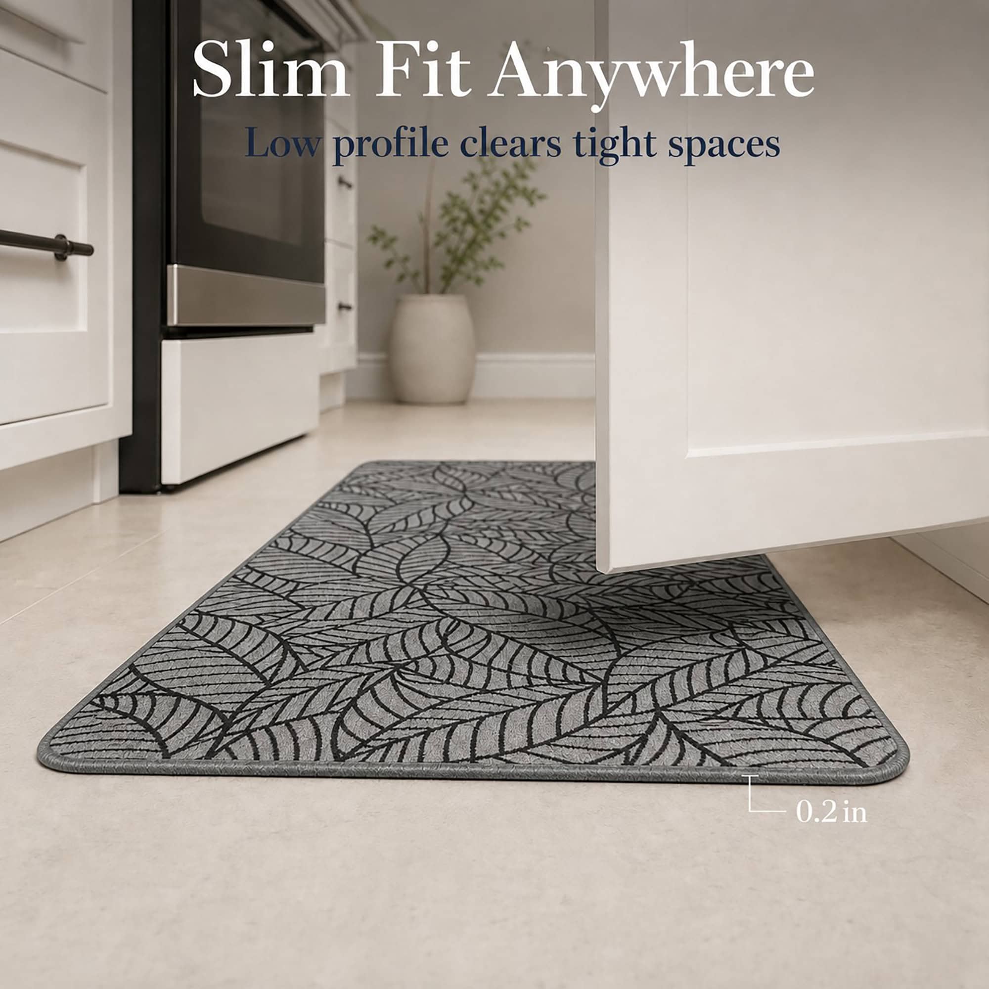 Grey leaf-print kitchen runner lying flat in a bright kitchen, its low two-tenths of an inch profile clearing tight spaces.