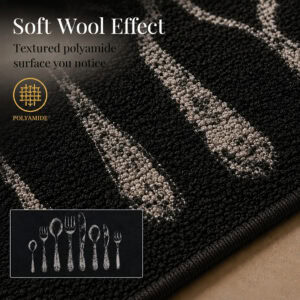 Macro close up of the black floor mat surface showing the textured polyamide pile with a soft wool effect and gray cutlery design detail.