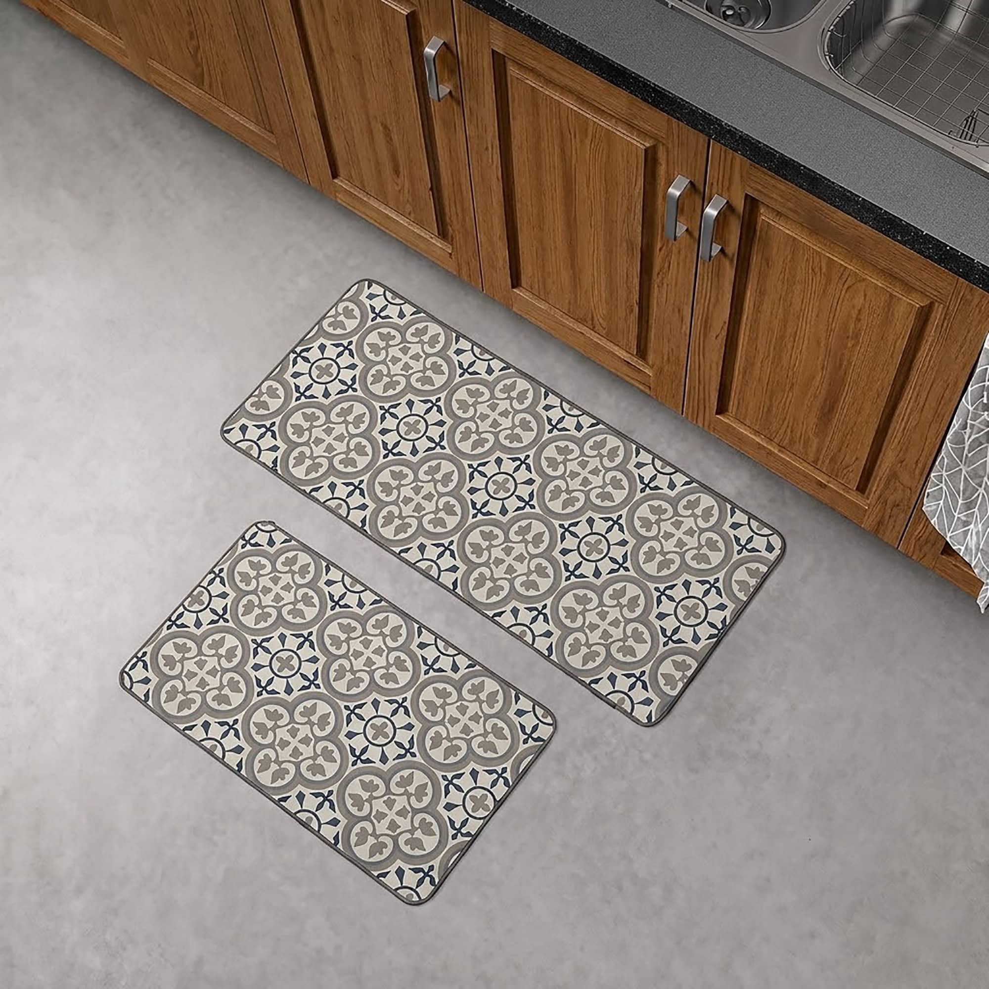 The runner and standard mat placed together on a gray floor in front of wood kitchen cabinets, showing both pieces of the set.