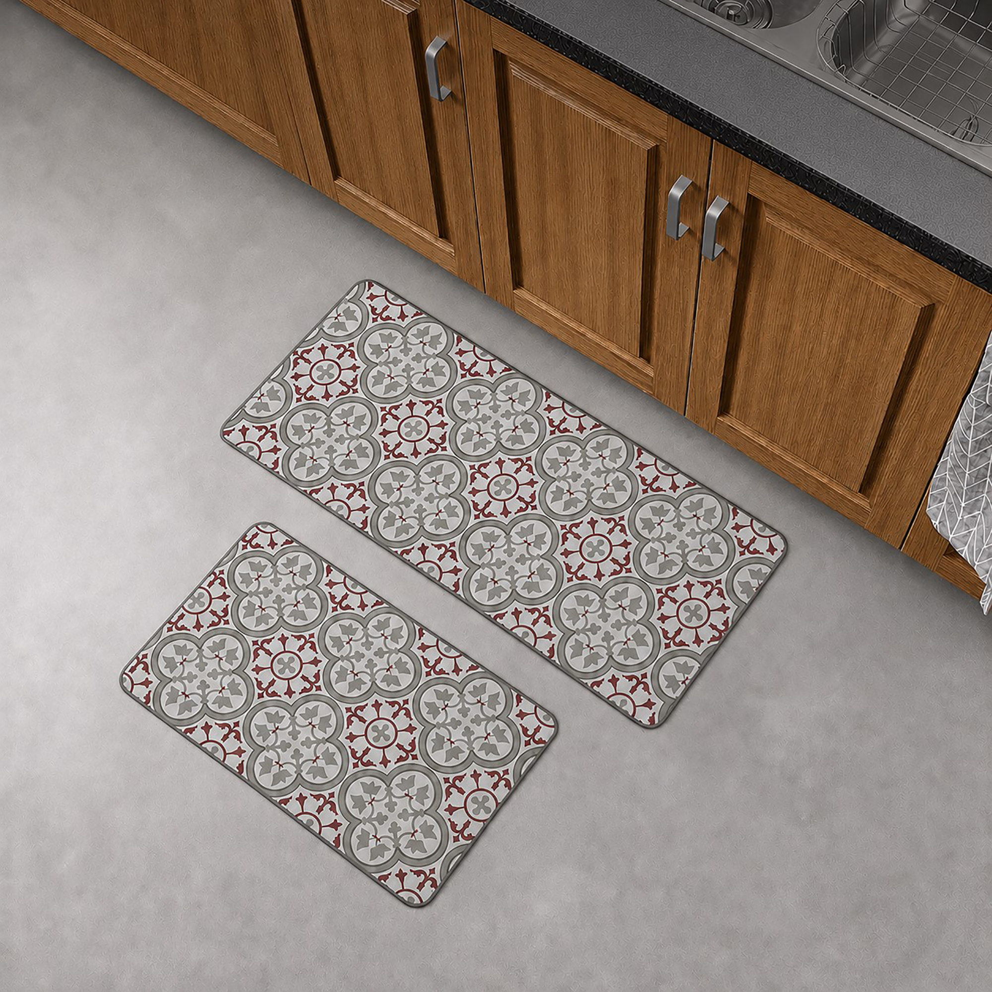 The runner and standard mat placed together on a gray floor in front of wood kitchen cabinets, showing both pieces of the set.