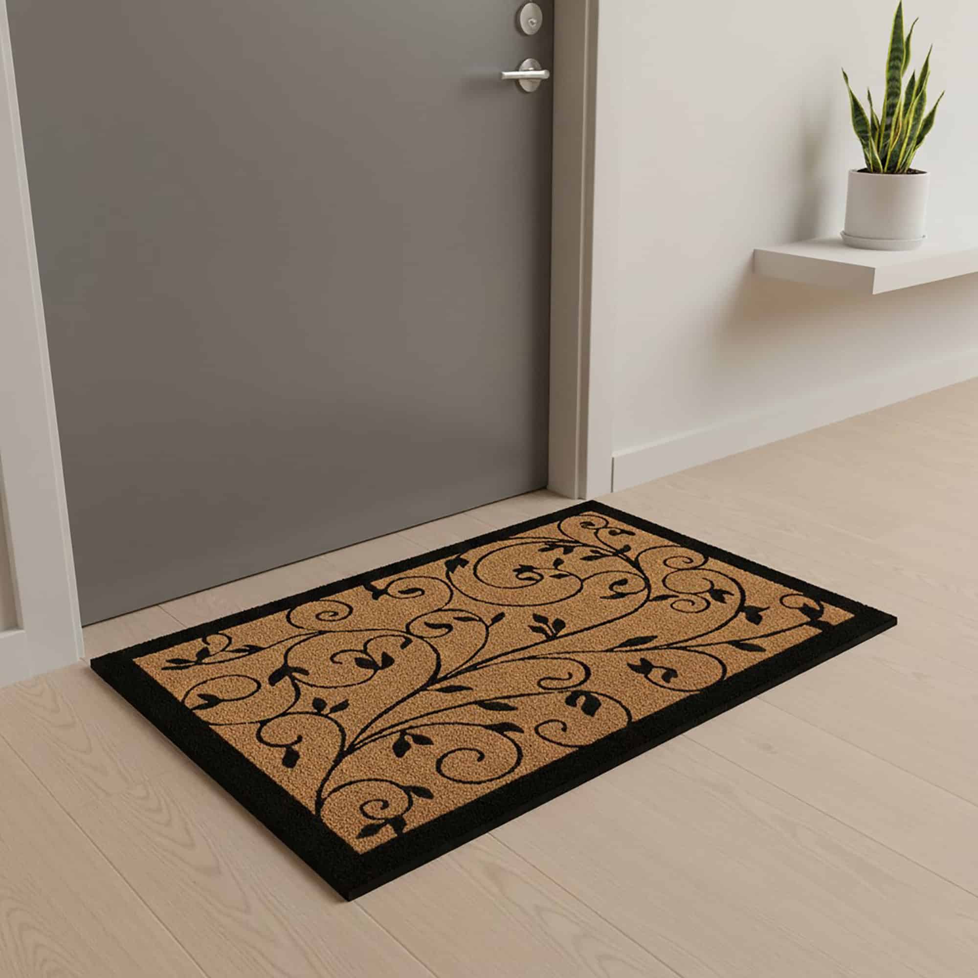 Leafy vine printed coir doormat placed inside hallway at grey apartment door