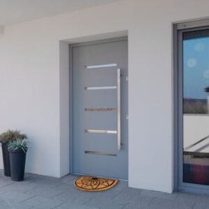 another view of entrance door with the coir doormat placed in front of the door