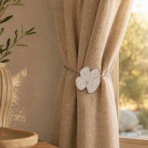 Lifestyle beige chaud: White water lily curtain tieback on a warm beige linen curtain in a cozy sunlit room