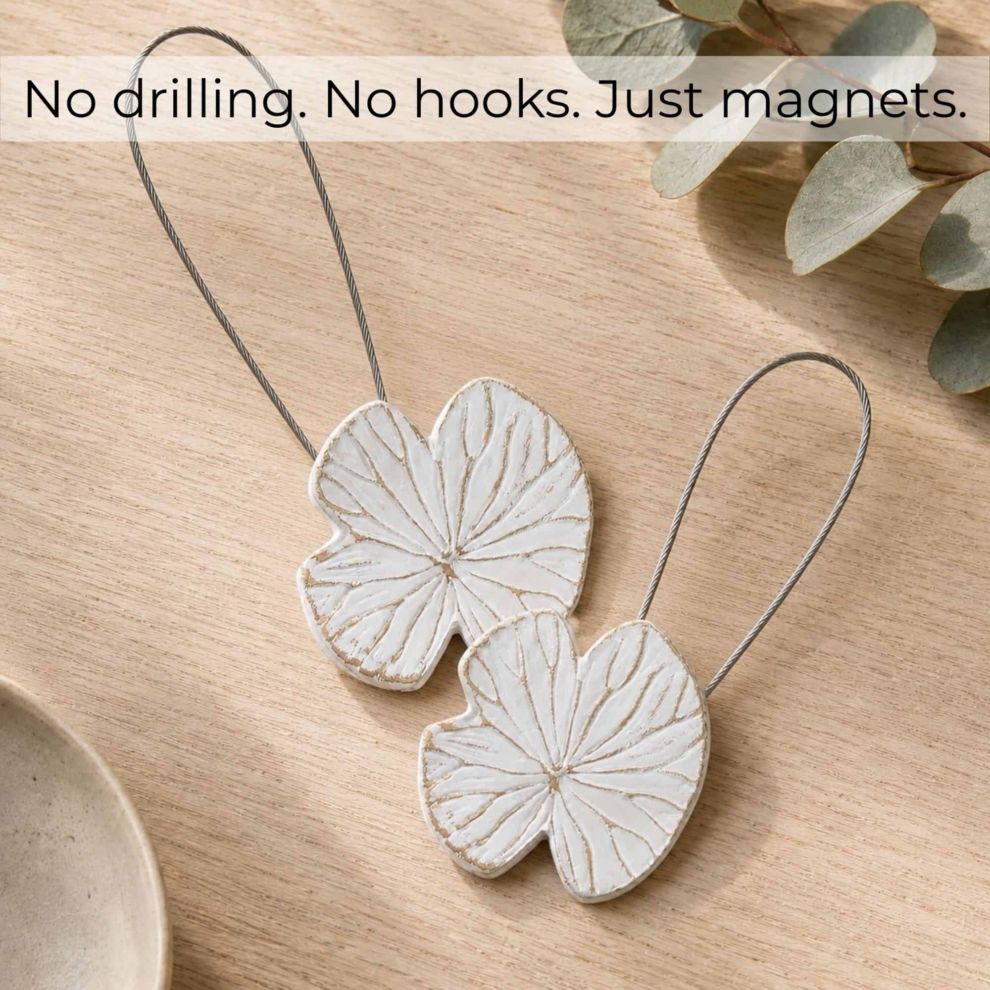 Flat-lay bois: Set of 2 white water lily magnetic curtain tiebacks on light wood, no drilling no hooks just magnets