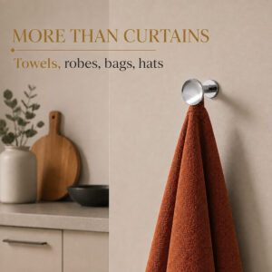 Chrome round wall hooks holding towels and robes in a bathroom, beyond curtain use