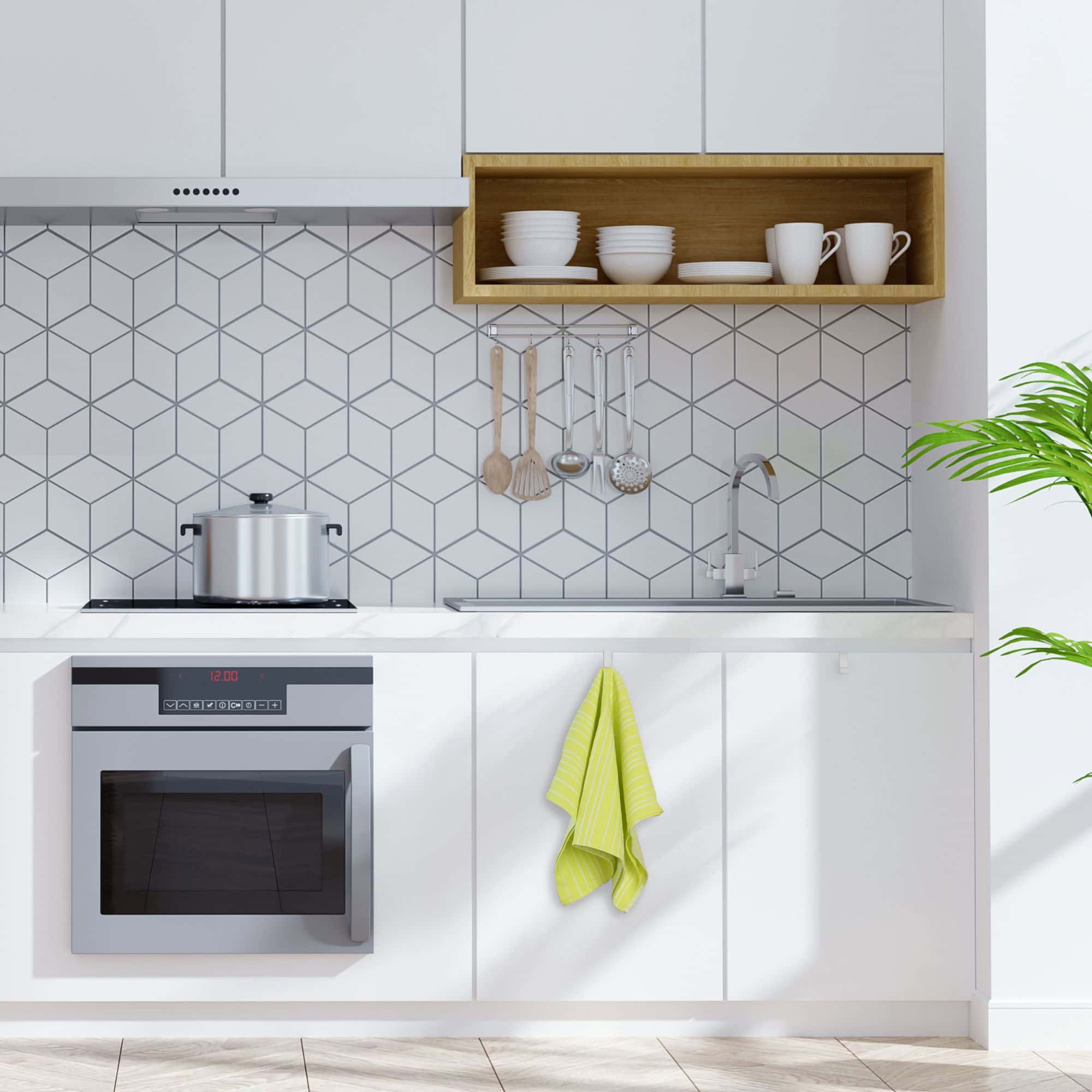 "White over-cabinet hook holding yellow striped dish towel on white kitchen cabinet door"