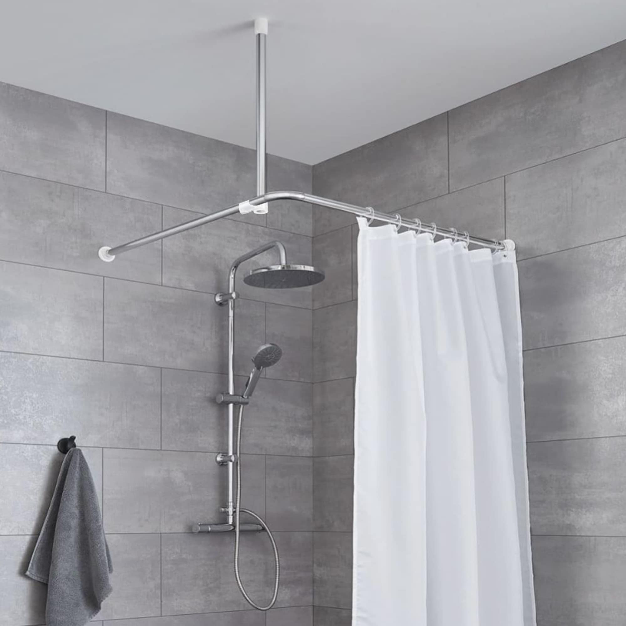Chrome ceiling support rod in a grey bathroom, with shower curtain and modern shower fixture