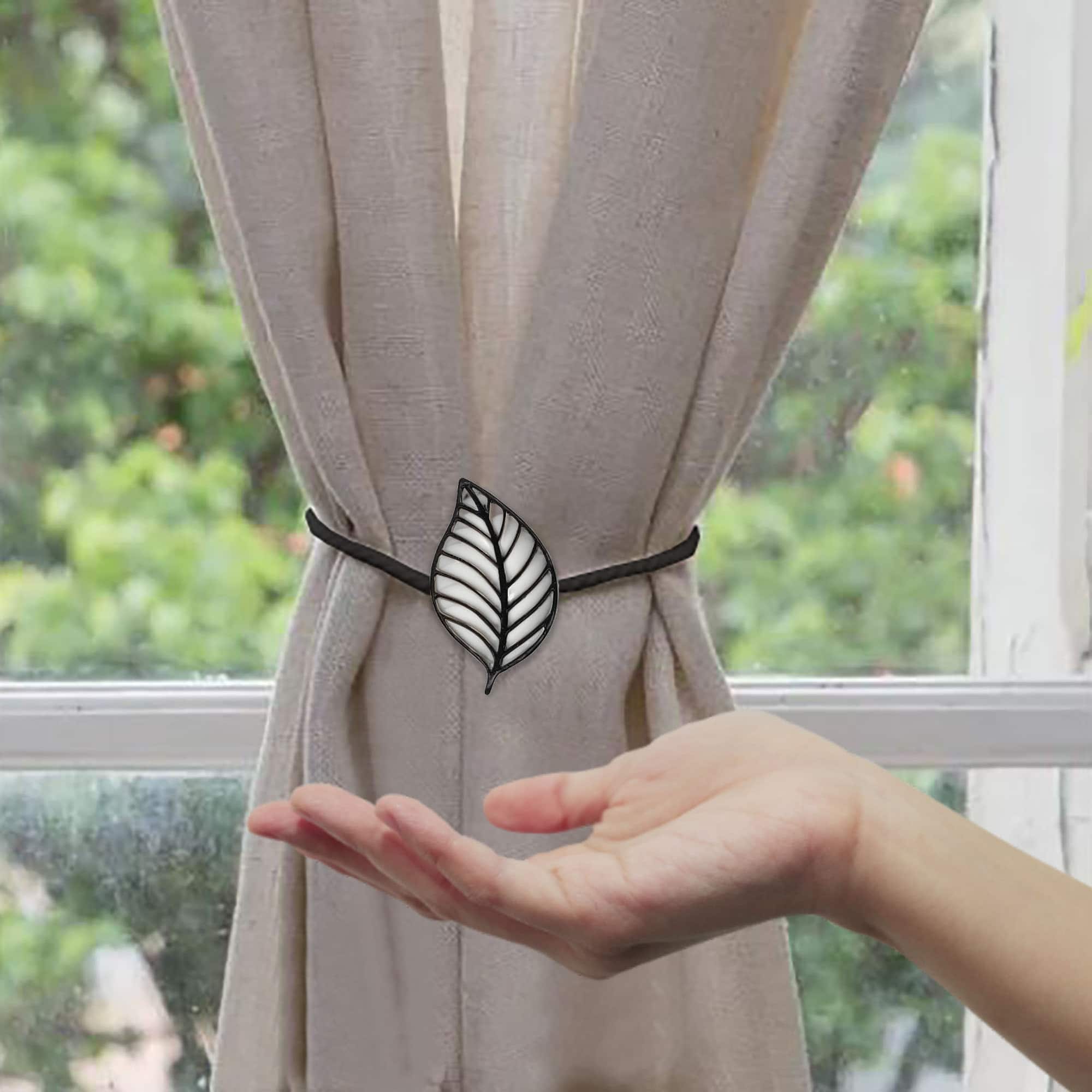 leaf tieback on curtain with woman hand