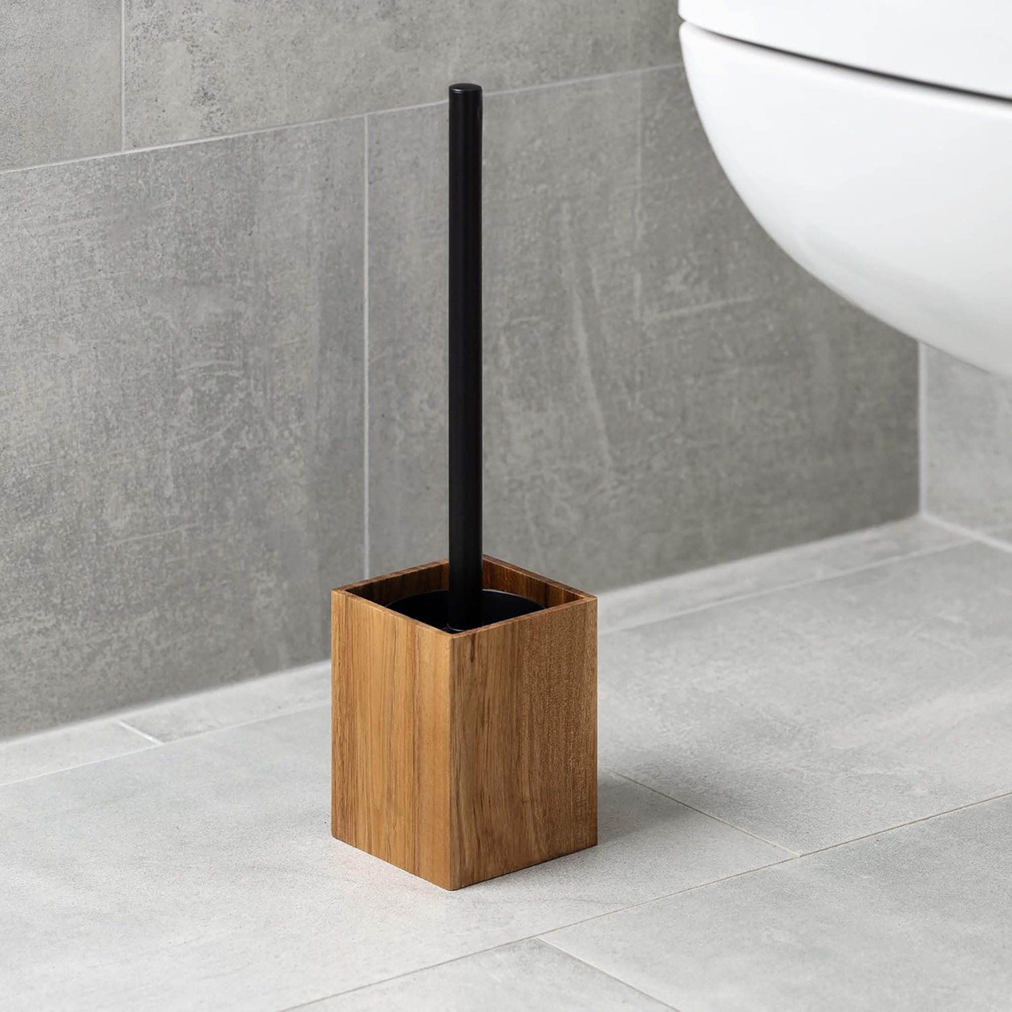 Wooden toilet brush holder with black handle on tiled floor
