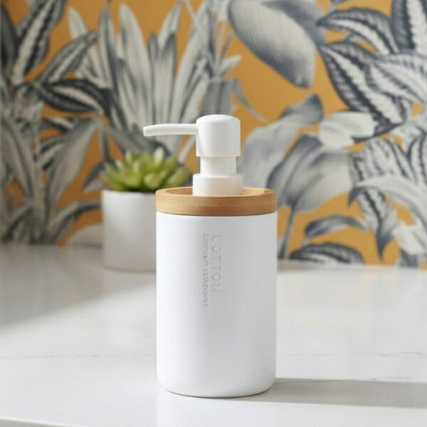 White bathroom lotion dispenser with bamboo top on vanity