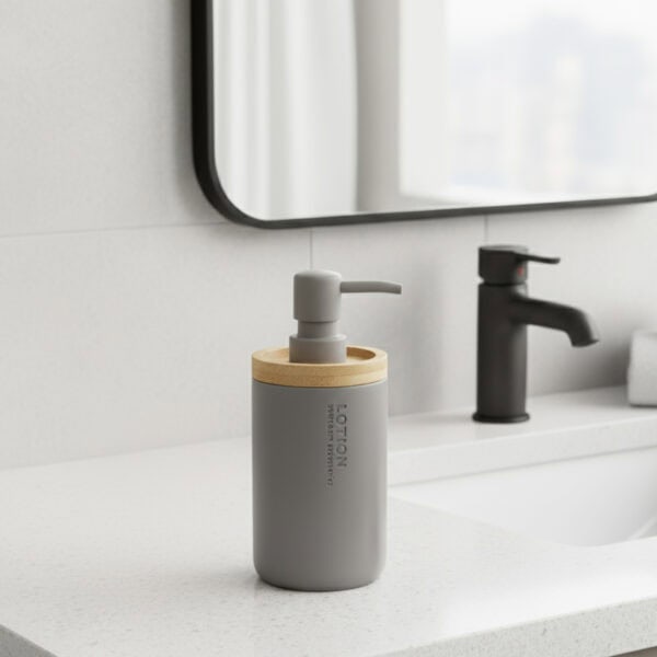 Gray bathroom lotion dispenser with bamboo top on vanity