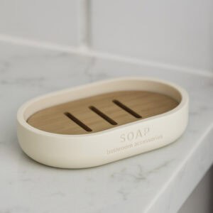 Matte beige soap dish with bamboo insert on marble countertop