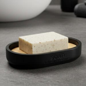 Matte black soap dish with bamboo base holding bar soap Matte black soap dish with bamboo base holding bar soap