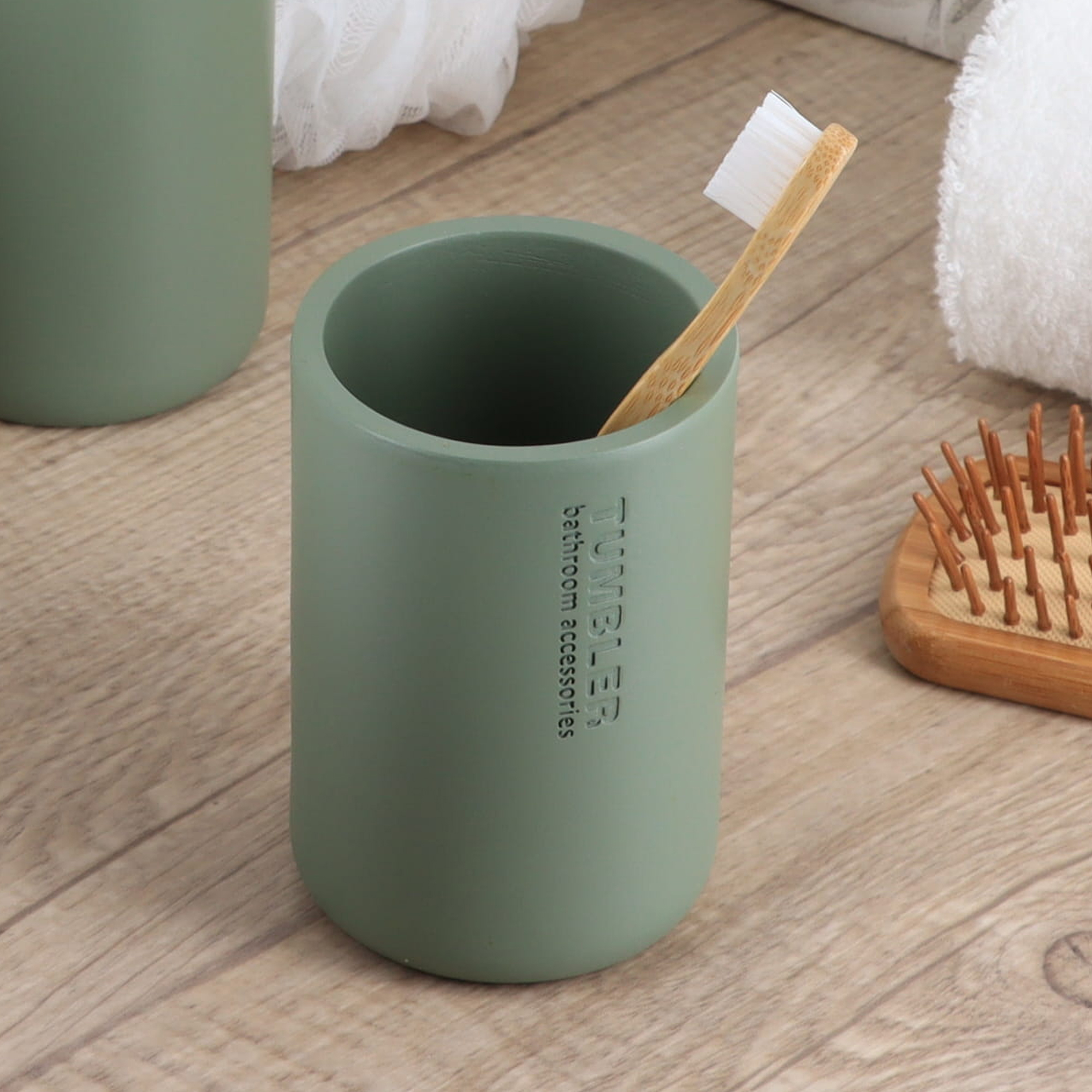 Minimalist matte green tumbler with engraved text close-up
