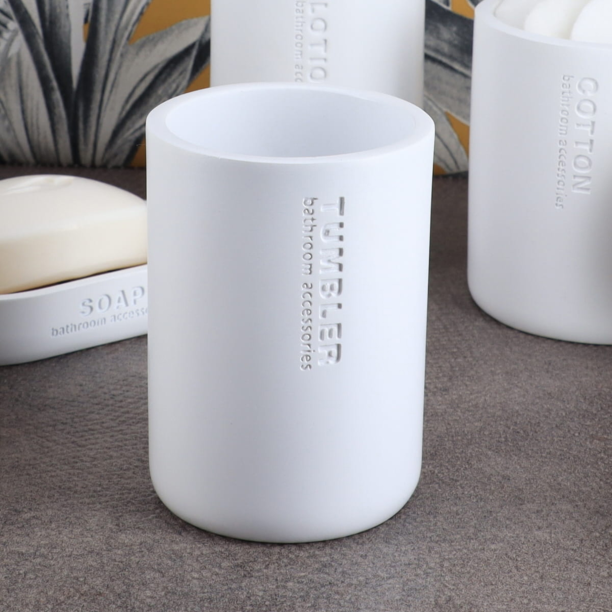 Minimalist matte white tumbler with engraved text close-up