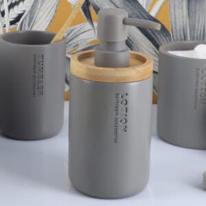 Gray dispenser styled with a bold tropical background