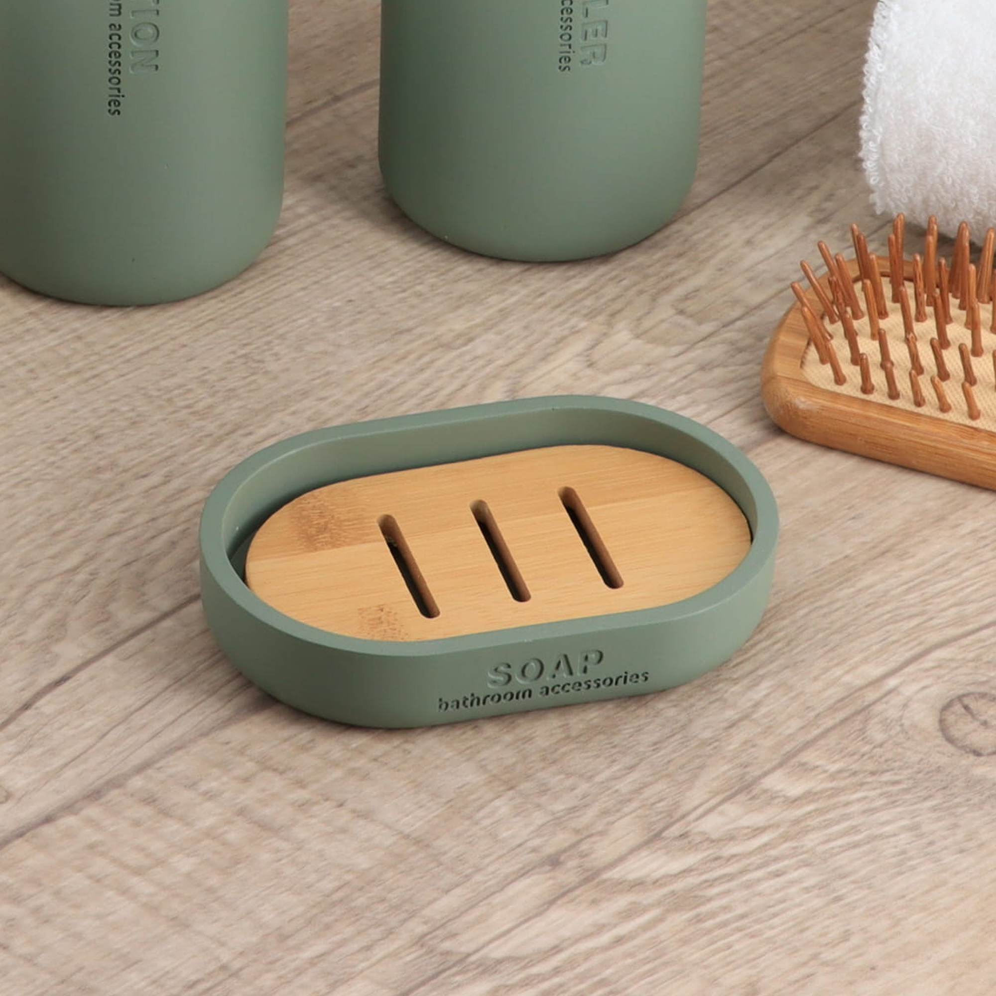 Green soap dish with bamboo insert styled with bathroom accessories