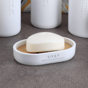 White soap dish styled with matching bathroom accessories