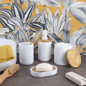 White bathroom accessories set with bamboo accents including soap dispenser, tumbler, soap dish, and cotton jar