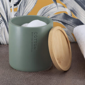 Cotton jar in green with a bamboo lid, displayed with a decorative and functional setup.